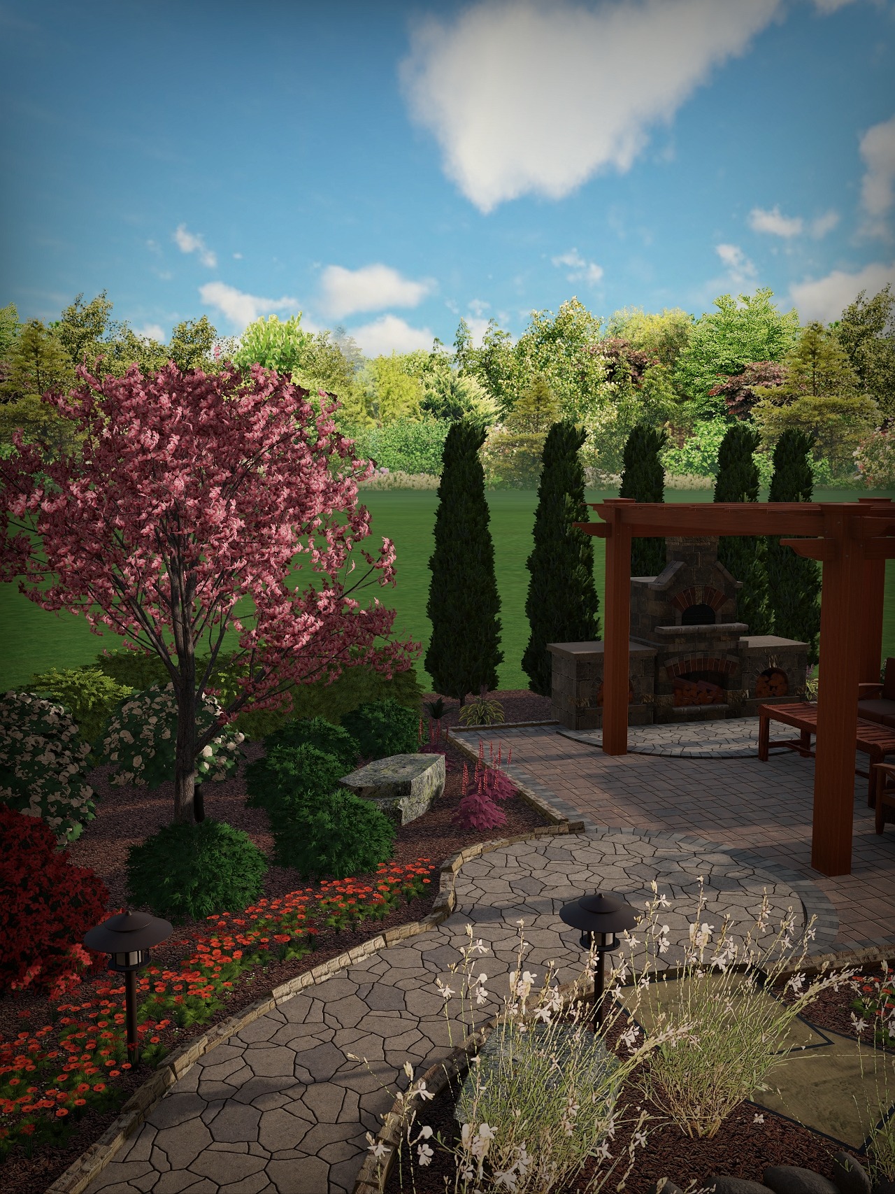 A beautifully landscaped garden with stone pathways, colorful flowers, patio area, and a wooden pergola under a bright blue sky with scattered clouds.